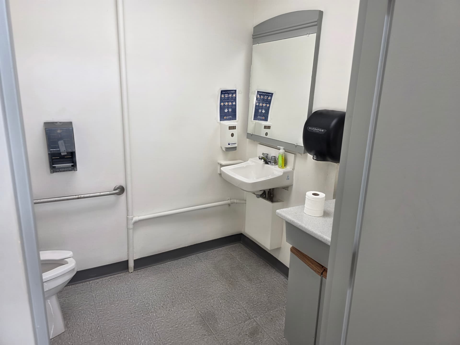 Accessible patient washroom with grab rails and sink