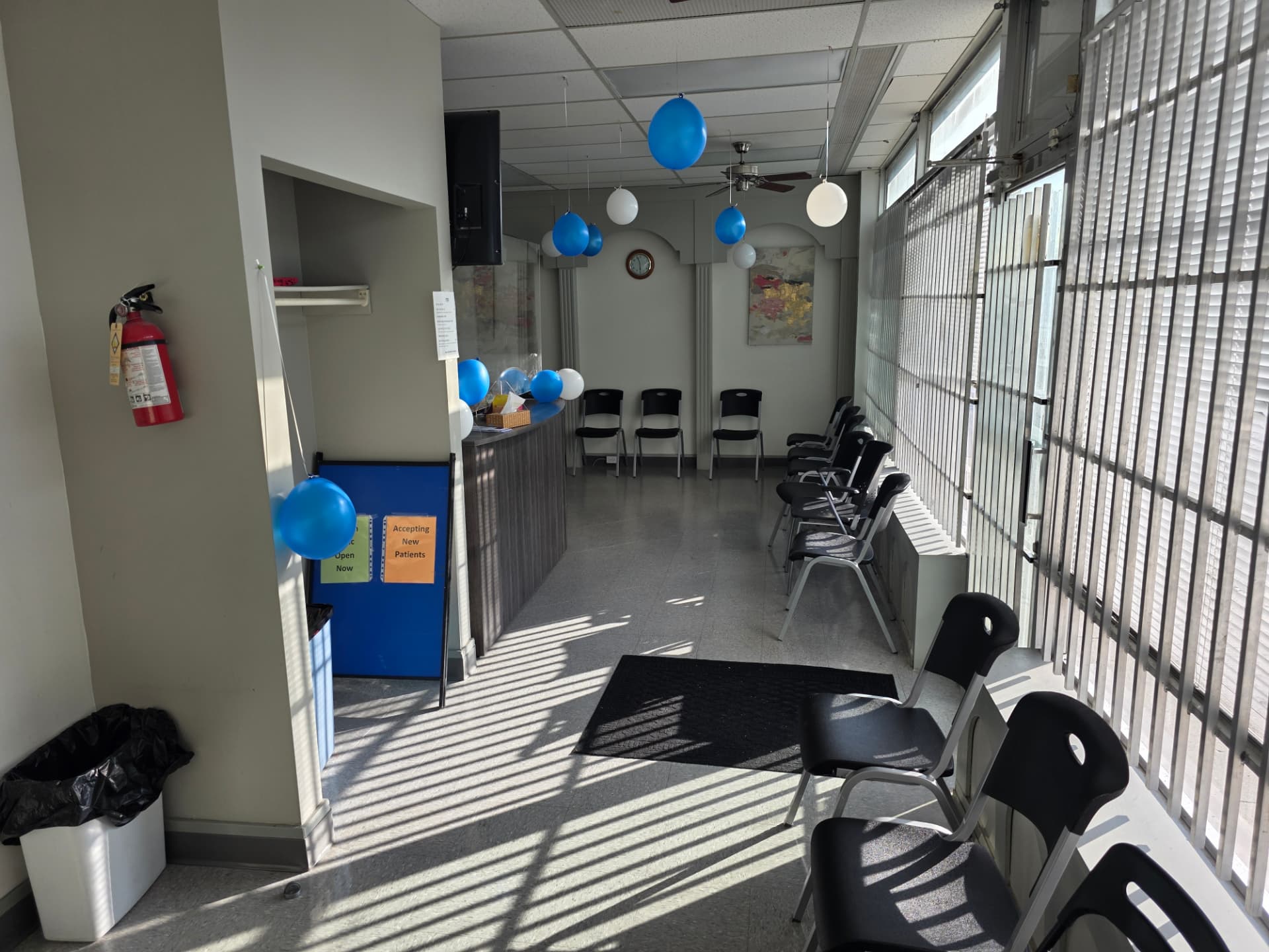 Sunlit waiting area with 'Accepting New Patients' sign at Jefferson Medical Centre
