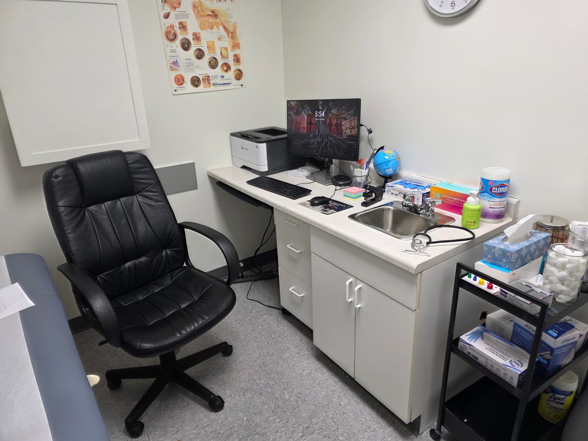 Consultation room with desk, chair and clinical supplies