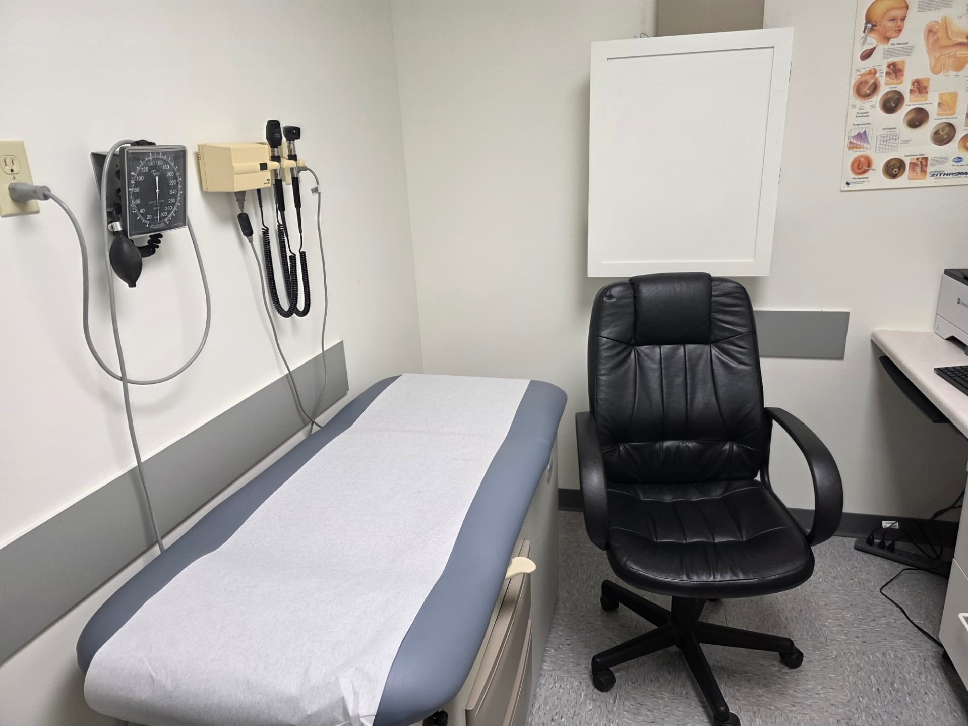 Examination table with blood pressure monitor and otoscope at Jefferson Medical Centre